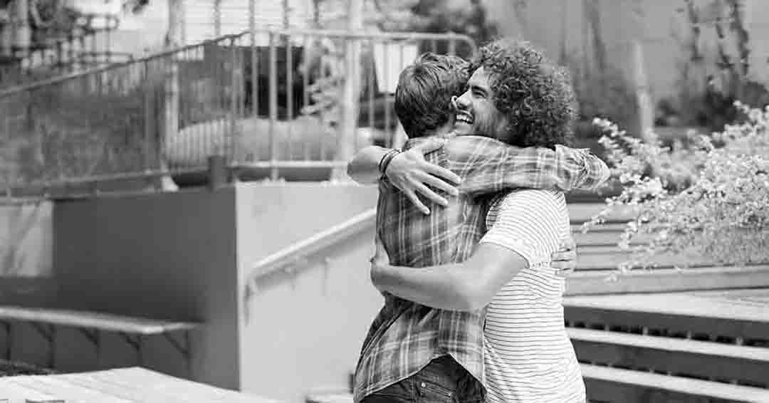 Image of 2 men embracing each other
