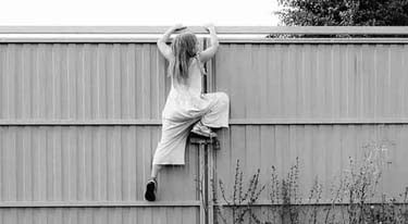 A girl climbing a wall